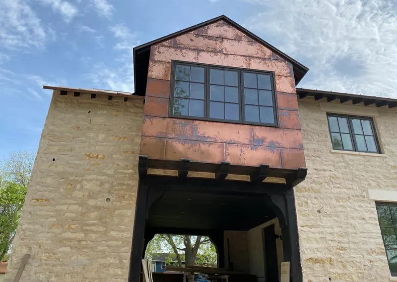 Copper metal panel facade on a stone building for Skylight Installation in Palm Harbor